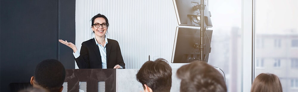 Businesswoman presenting to a group in a corporate environment.