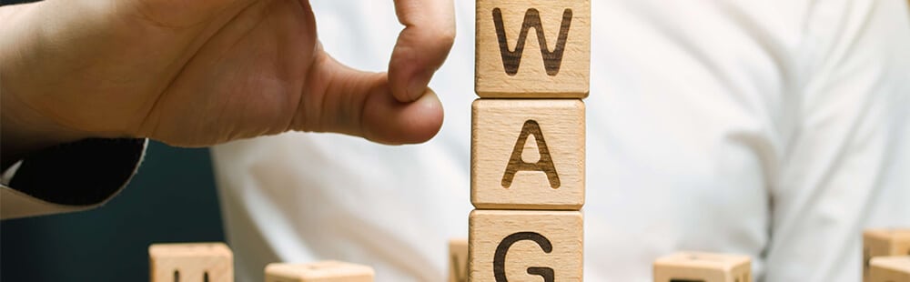 Wooden blocks spelling "WAG" for branding or marketing.