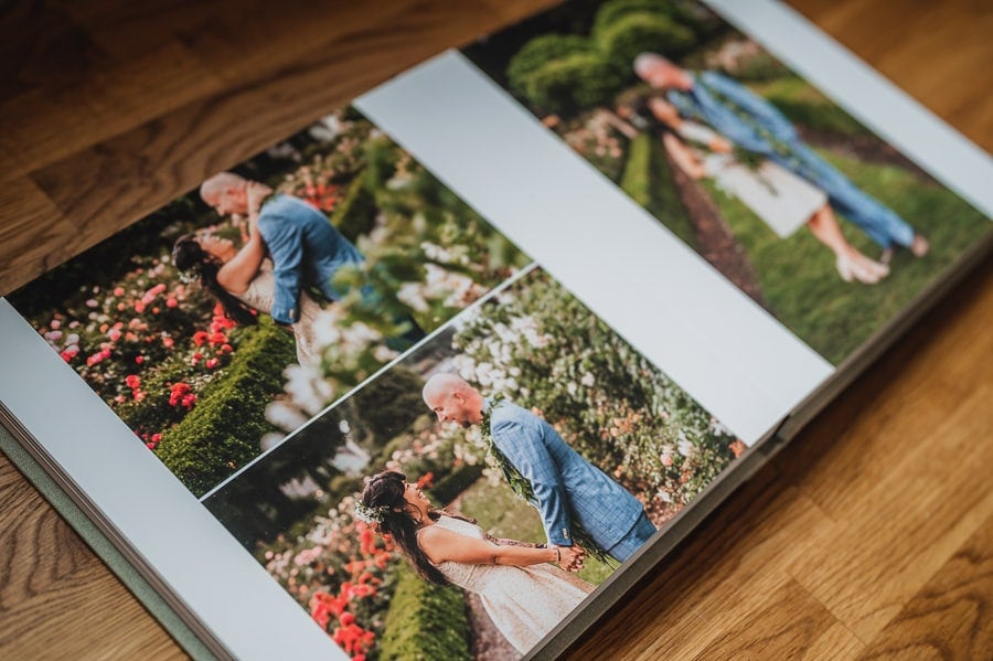 A wedding album with a full page layout of three photos with a bride and groom embracing in a rose garden, designed by Portland, Oregon wedding and elopement photographer Kyle Carnes.