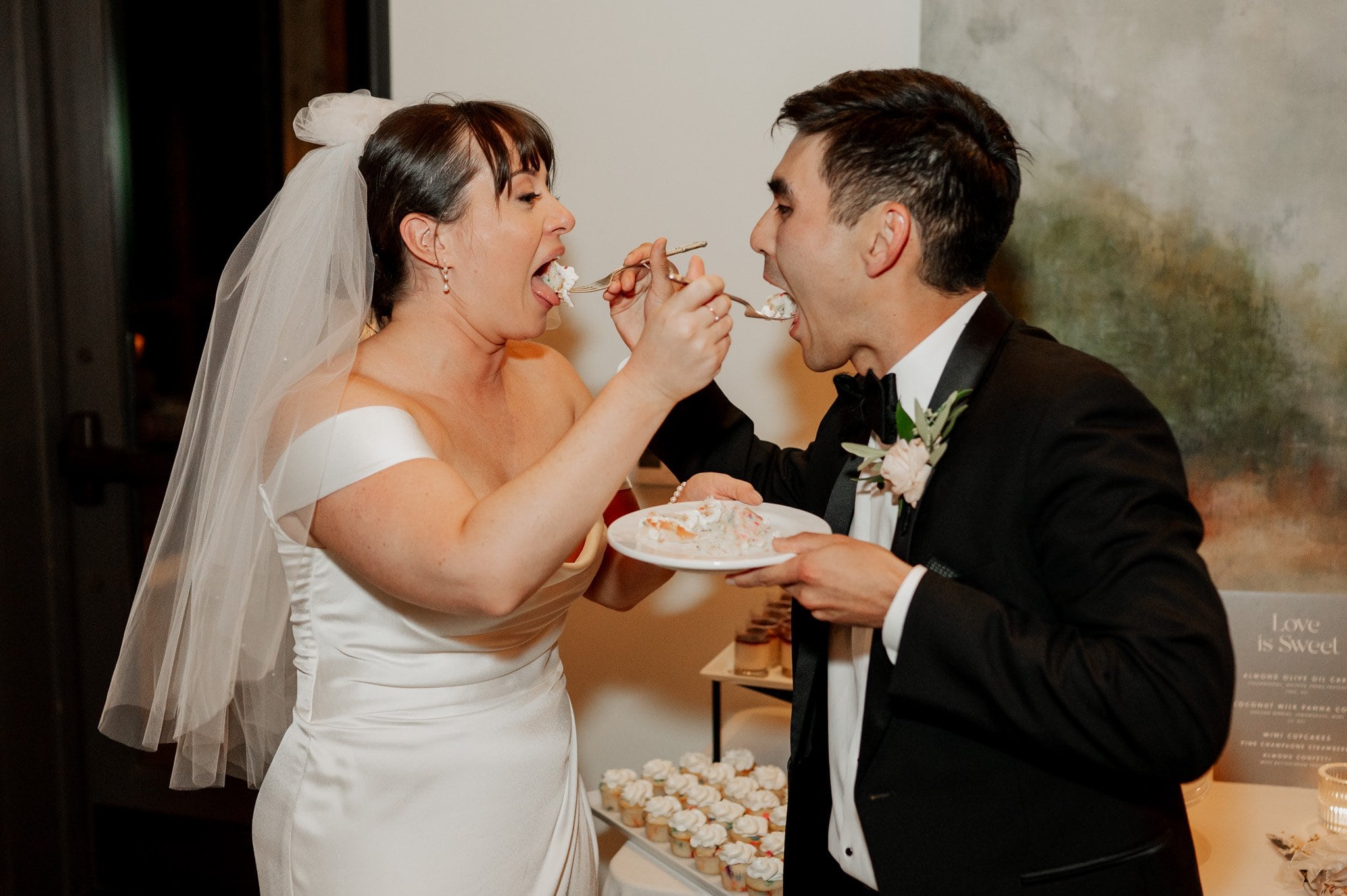 At their Amaterra Winery wedding, the bride and groom shared laughter and cake as they fed each other, creating a moment captured beautifully in their photos.