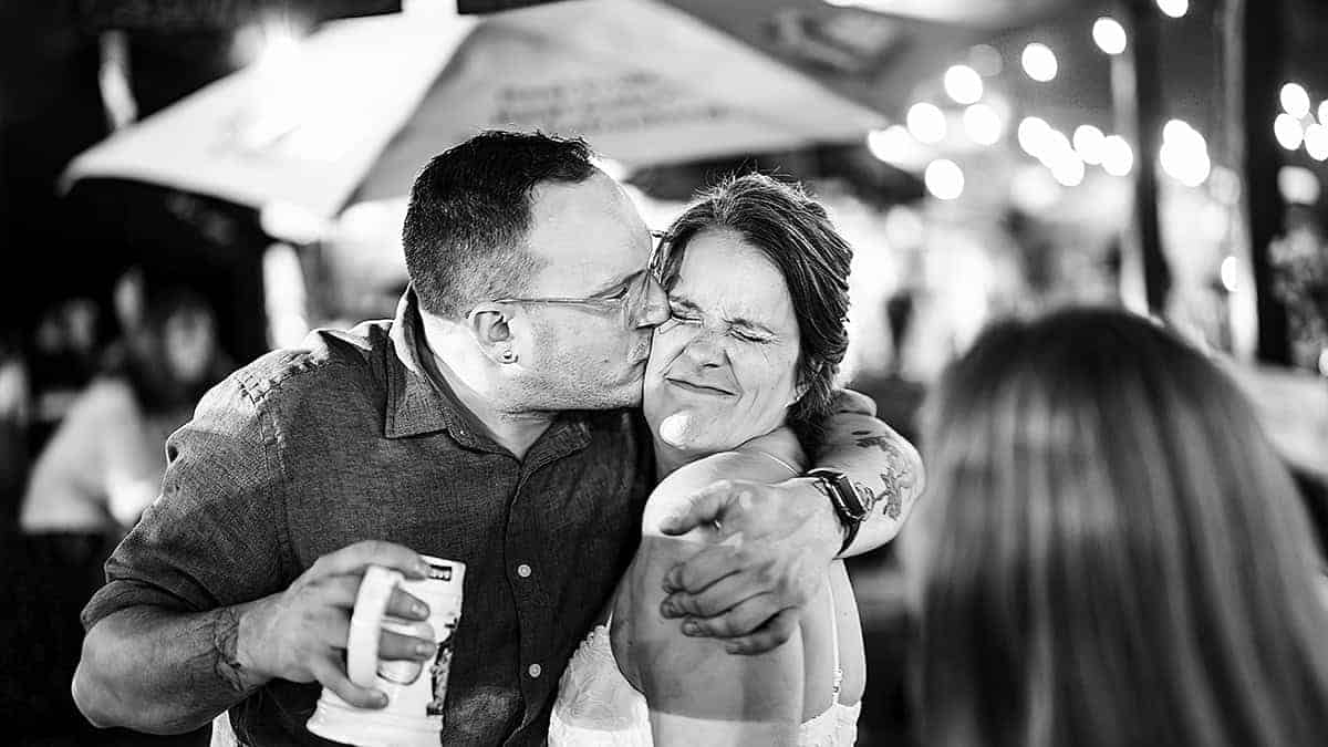 Candid moment of couple hugging during wedding reception in fairfield County