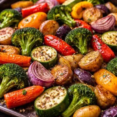 Colorful roasted vegetables including zucchini, carrots, potatoes, and onions.
