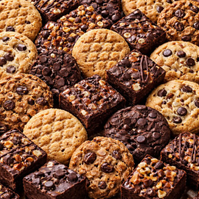 Variety of cookies and brownies on dessert tray for sweet treats.