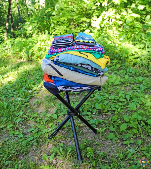 clean laundry folded on a stool