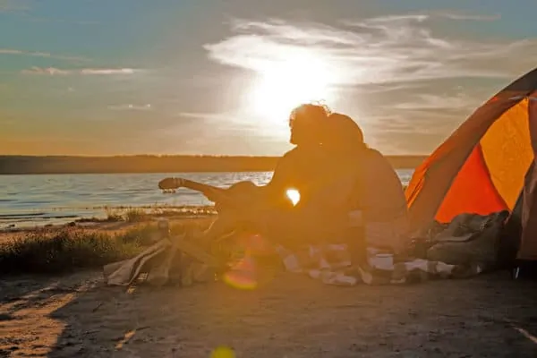romantic couple camping with a tent