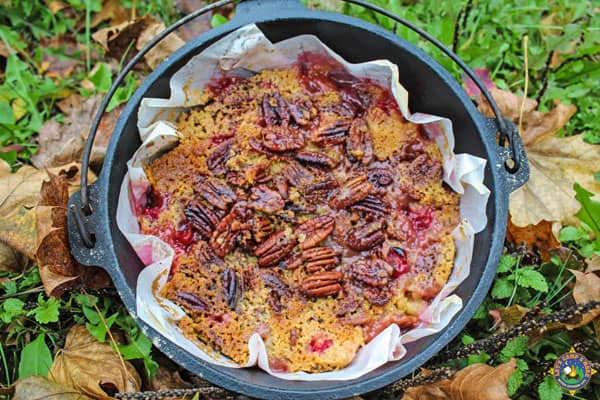 Dutch Oven with a Cran Apple Dump Cake with pecans on top