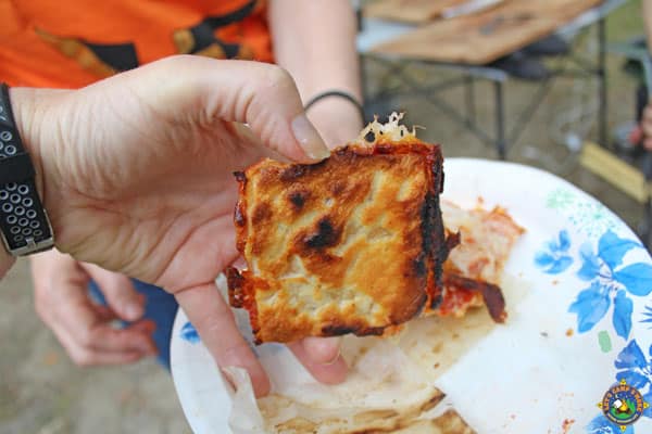 the bottom of a crispy crust being held up