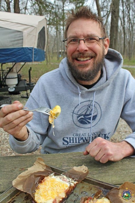 Eating Breakfast in a Bag smiling man enjoying a camping breakfast
