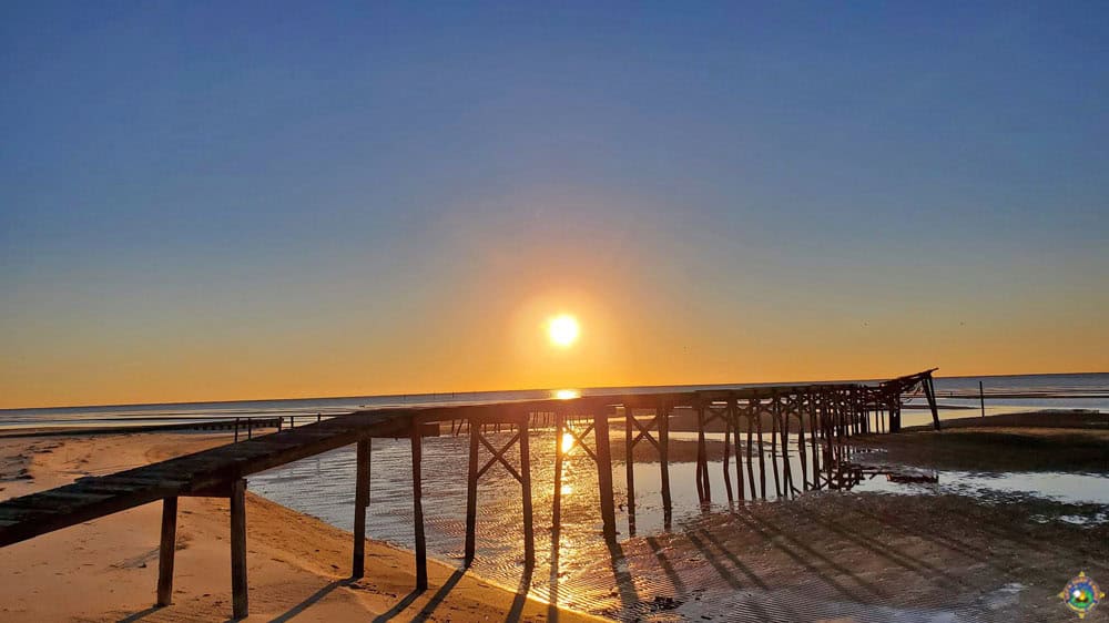 sunrise over a pier in the Gulf of Mexico in Mississippi