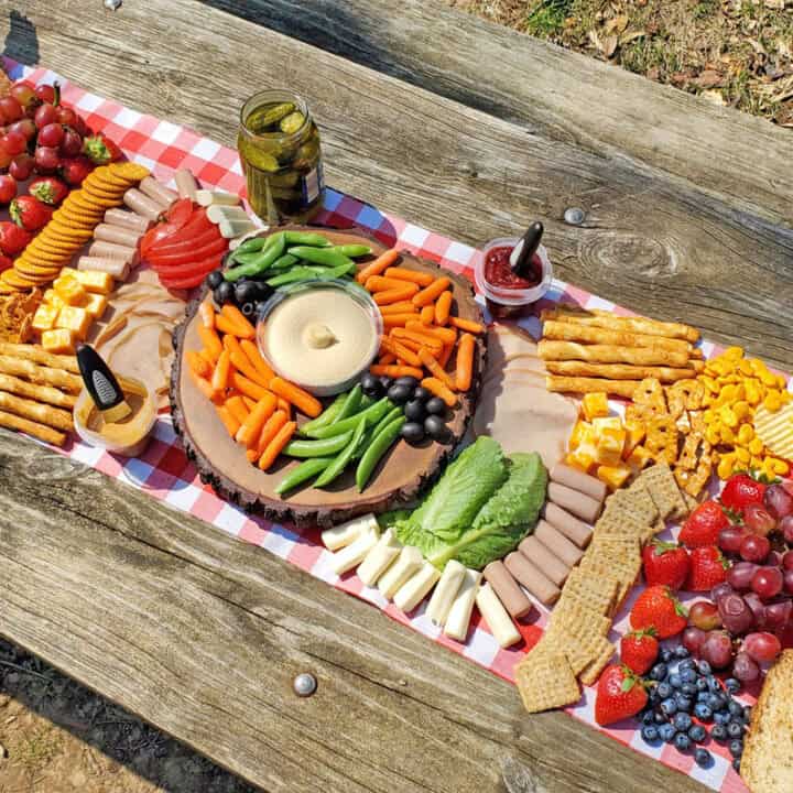 overhead view of a charcuterie board on a picnic table