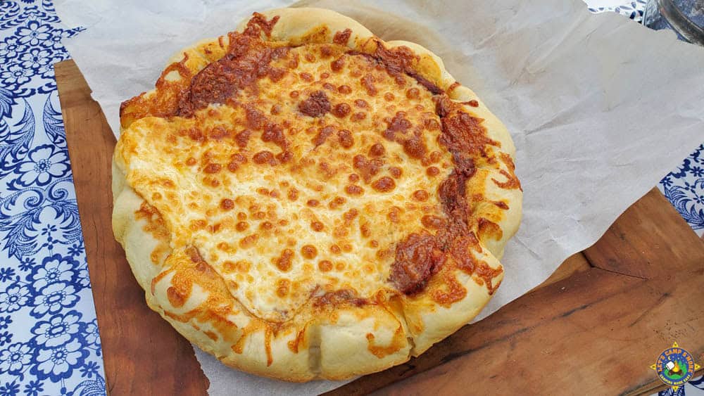 homemade cheese pizza baked in a Dutch oven