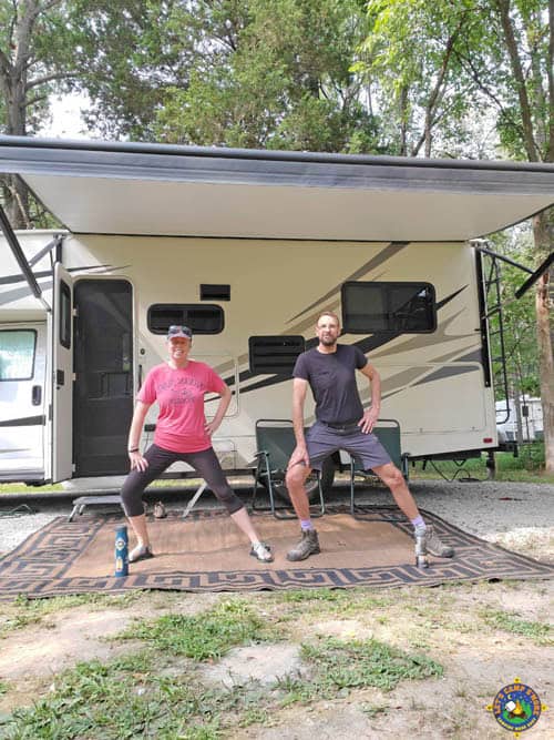 couple stretching outside of a motorhome