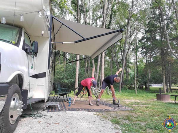 couple stretching during a exercise class at a campsite