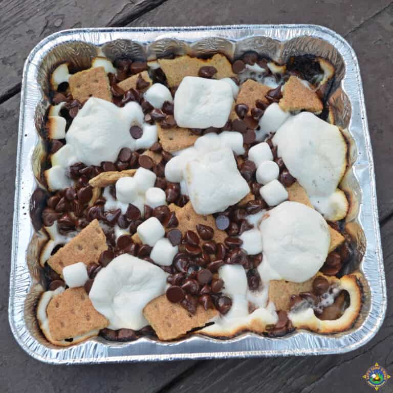 foil pan of S'more Nachos made over a campfire