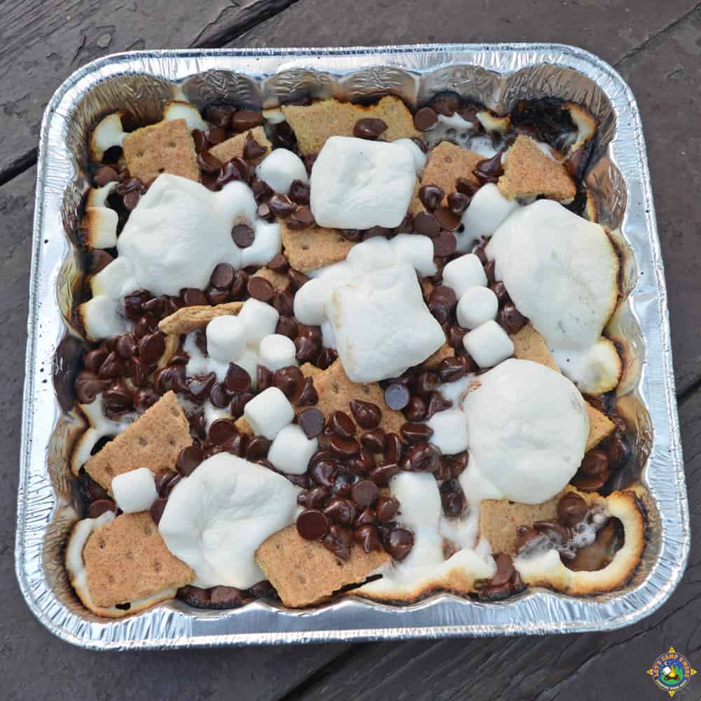 foil pan of S'more Nachos made over a campfire