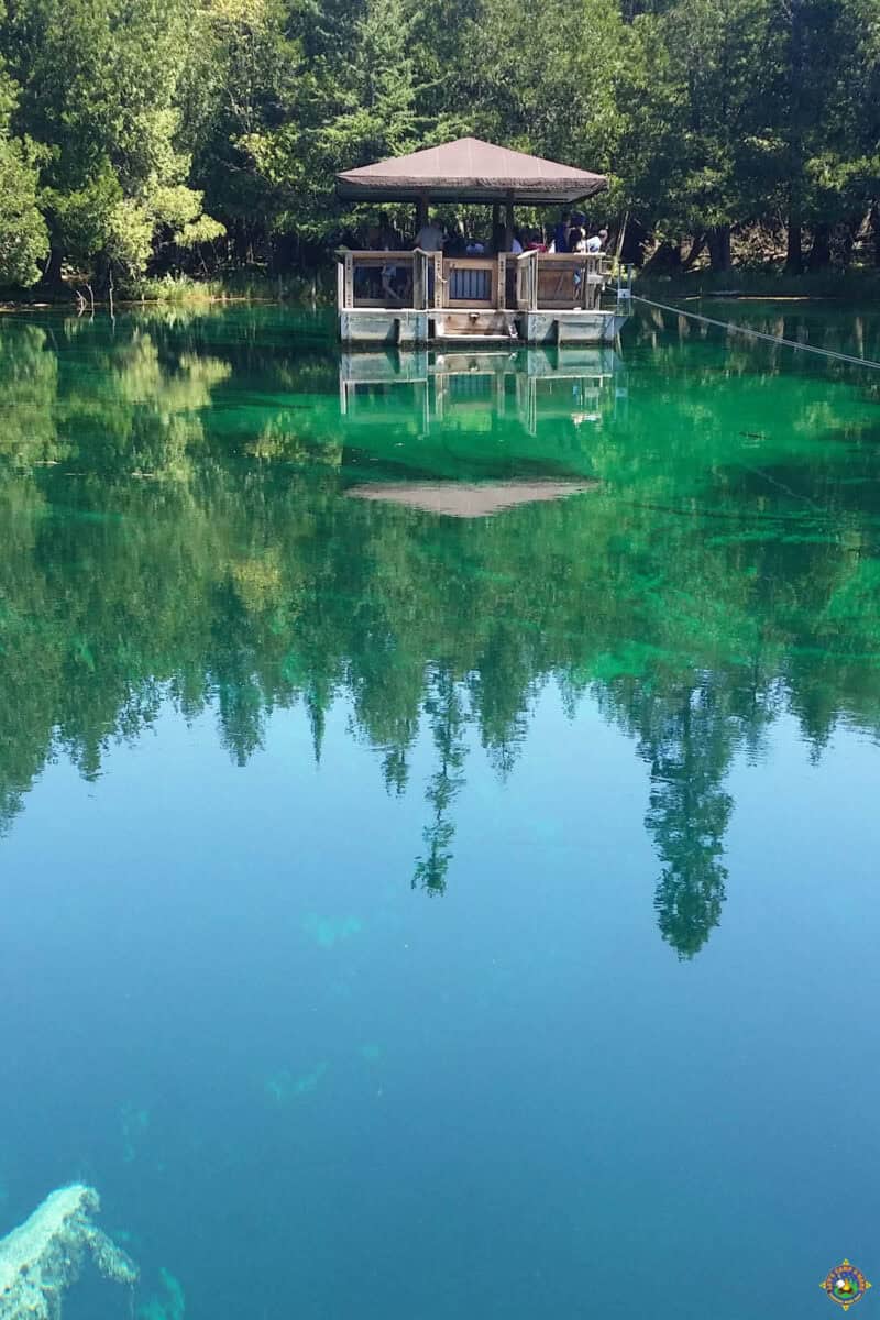 People on the floating platform at the Big Spring of Kitch-iti-kipi in the UP of Michigan