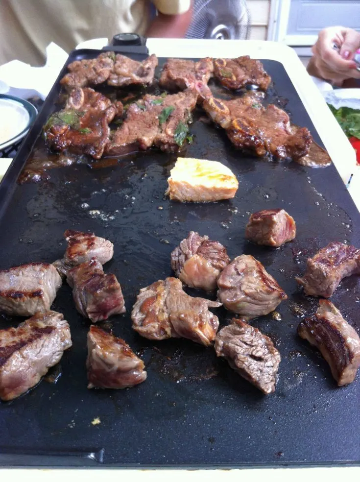 steak being cooked on a griddle