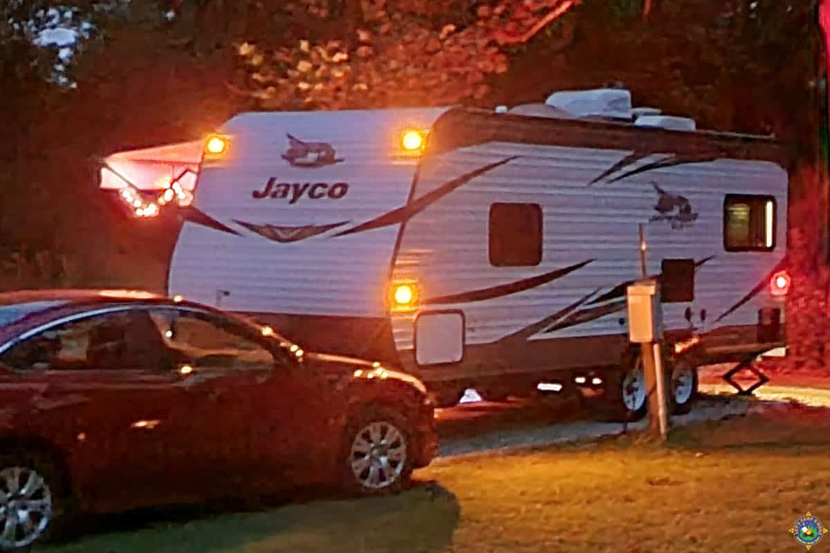 camper with the running lights on at night