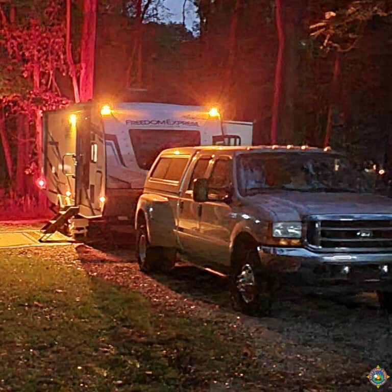 camper with the running lights on at night