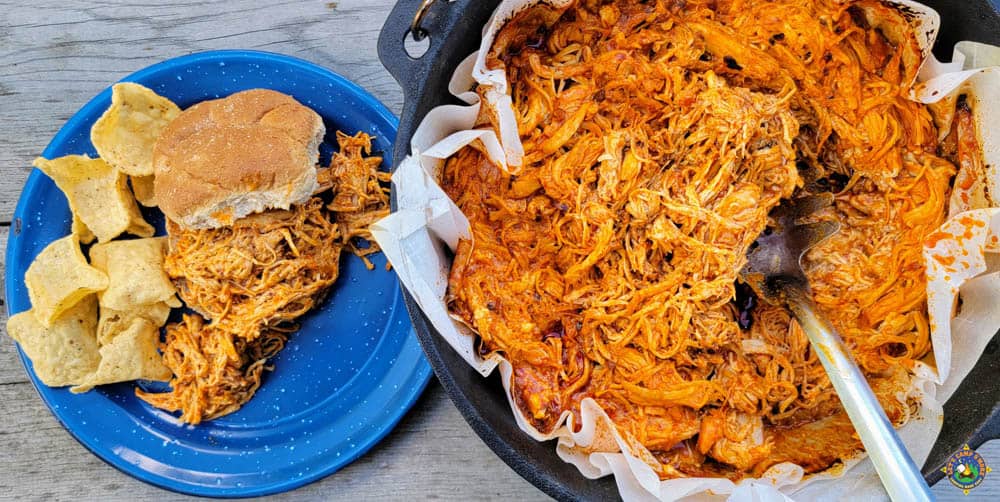 Buffalo Wing Chicken in a Dutch Oven with a sandwich on the side