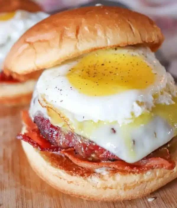 burger loaded with bacon and an egg