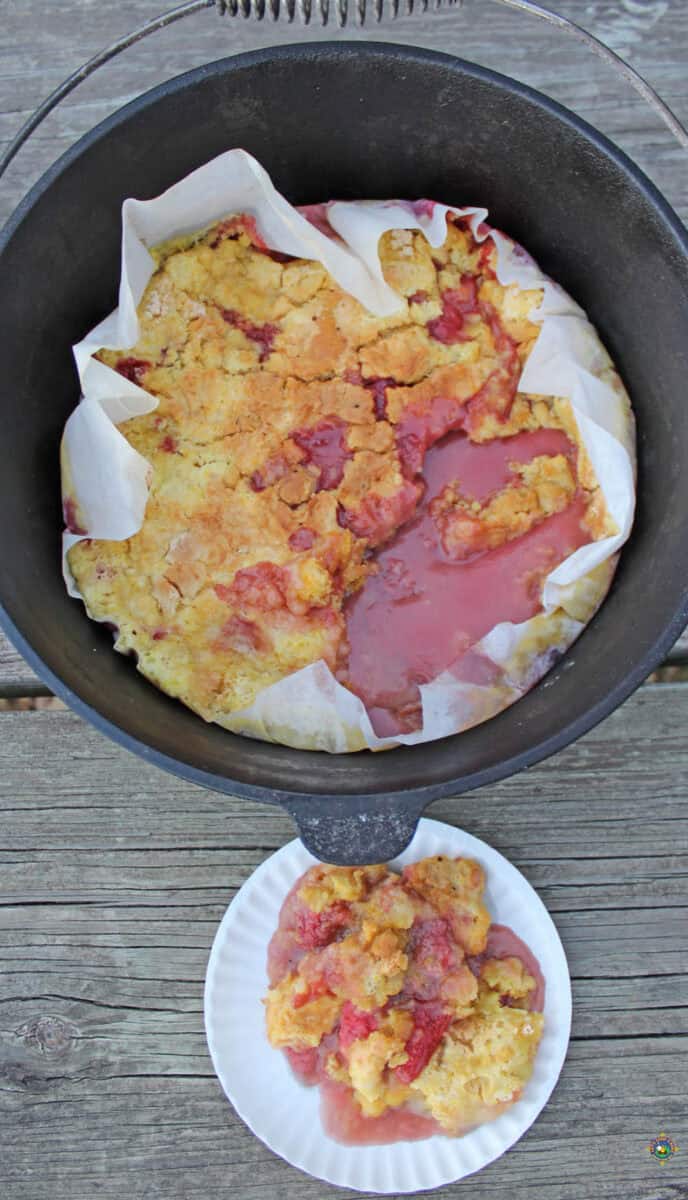 Lemon Strawberry Cobbler in a Dutch Oven with a serving on a plate