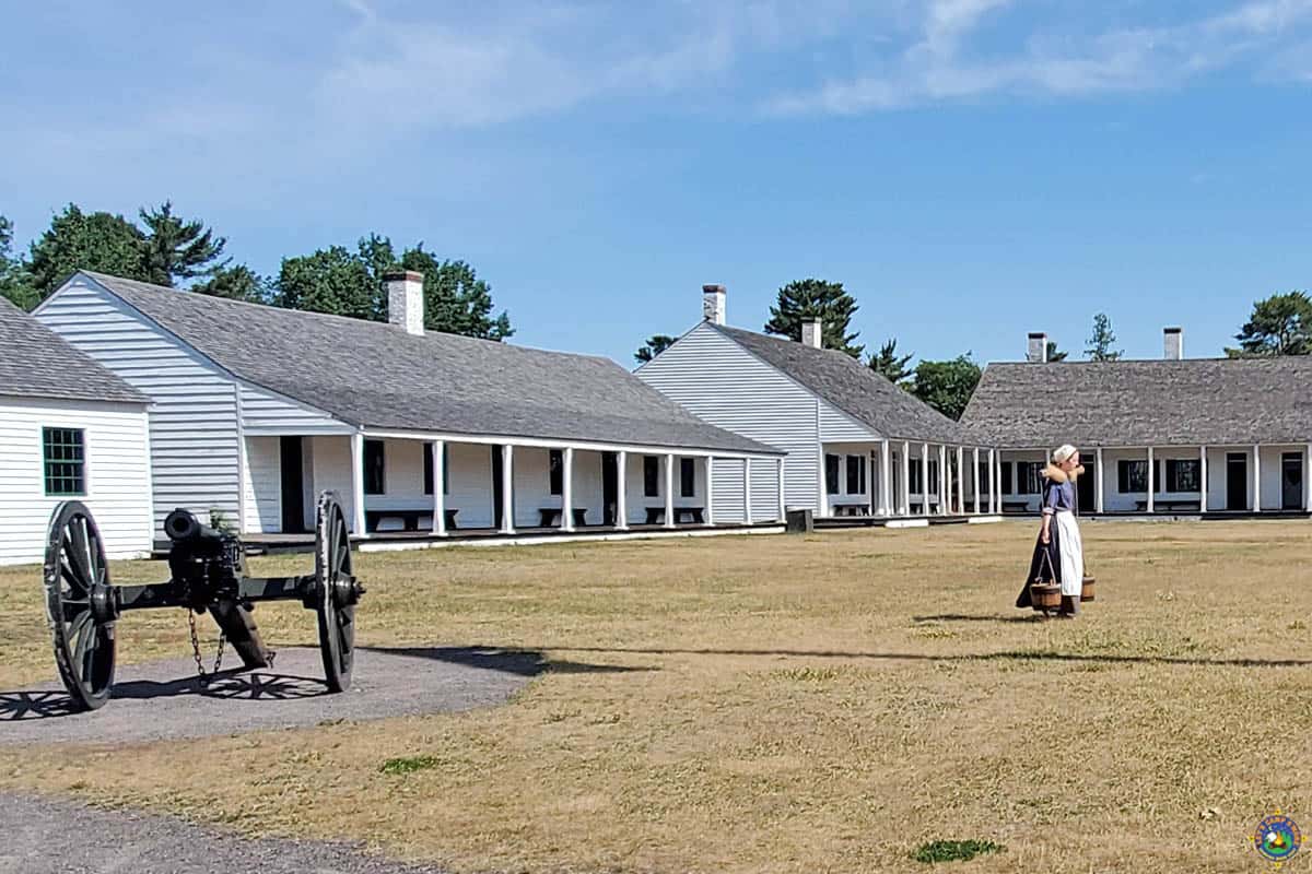 Fort Wilkins Historic Site with Costumed Woman Carrying Water