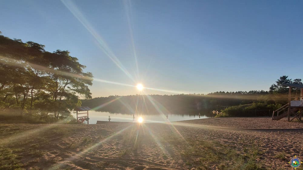 Tourist Park Beach with the Sun reflecting in the lake