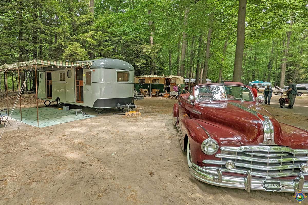 vintage car and camper at in a campground