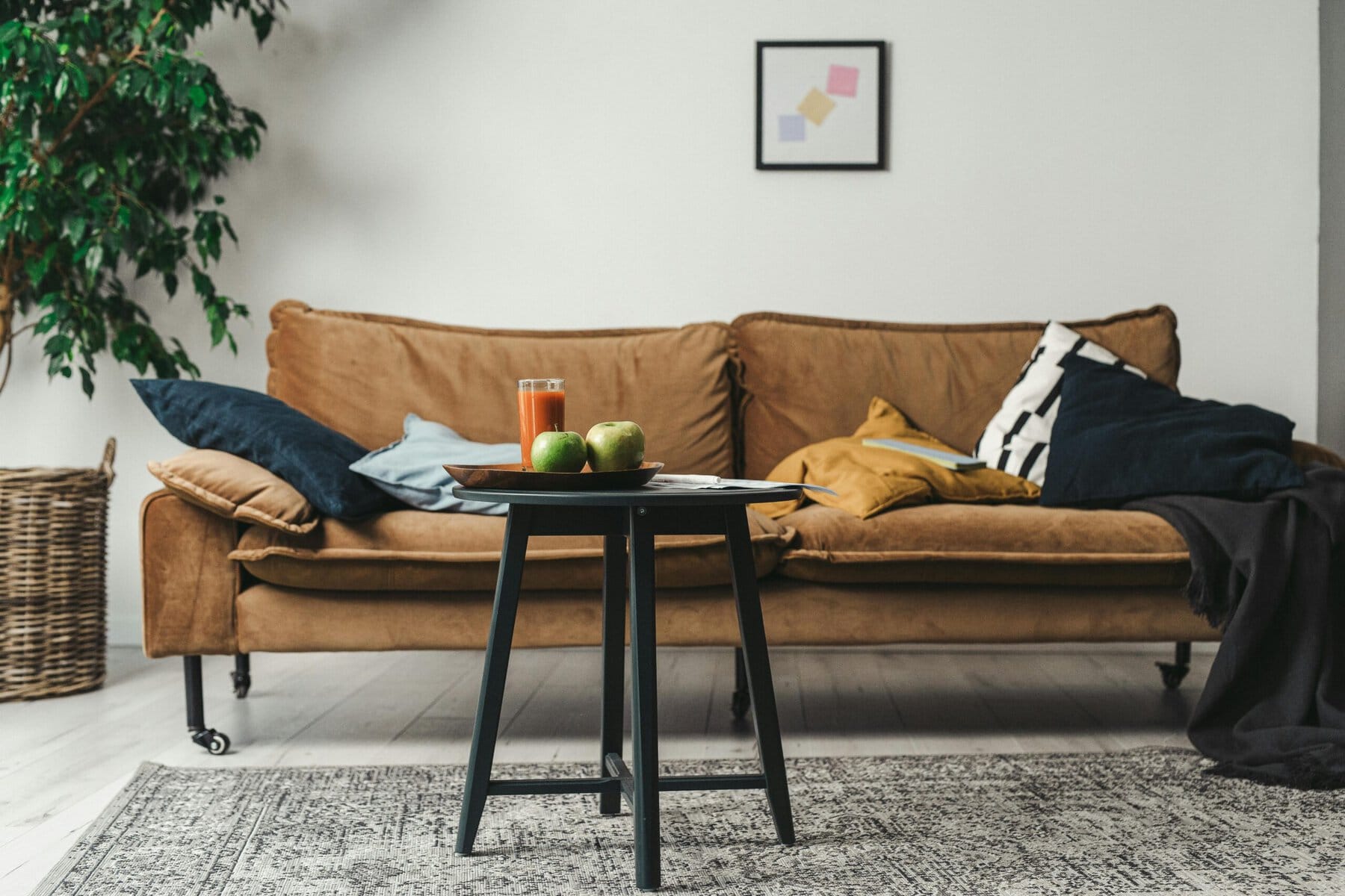 Comfortabele woonkamer met bank, planten en decoratieve elementen.