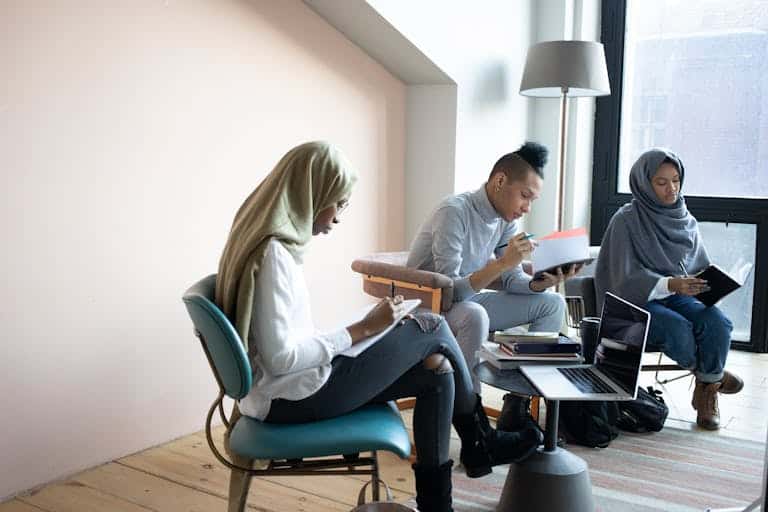 A diverse group of young adults working collaboratively in a modern office setting.