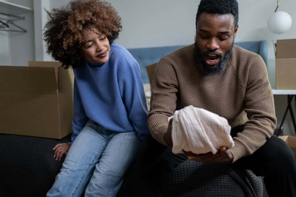 A joyful moment of a couple unpacking in their new home, embracing new beginnings.