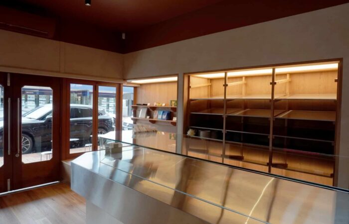 Shop Fit Out Auckland: What Needs Consent, What the Joinery Has to Survive, and How to Trade Through It 2 Full-height timber display shelving running the length of the Mibo Bakery fitout, facing the glazed shopfront