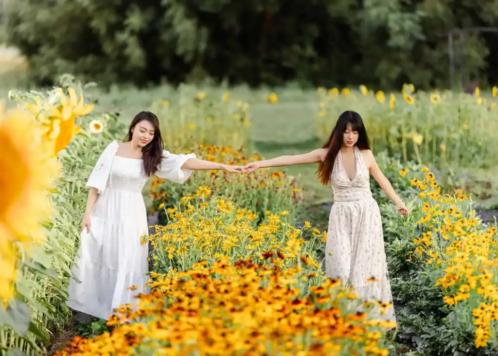 Candid family photo in a flower field with soft evening sunlight