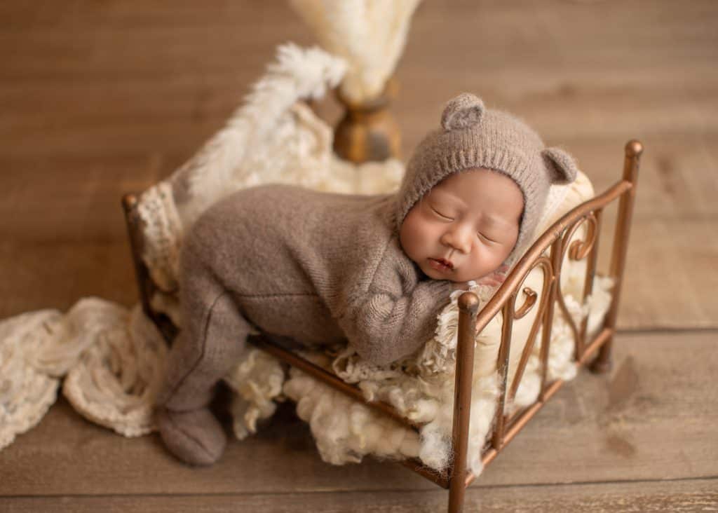 Newborn in a neutral-toned setup with soft textures and natural styling in Edmonton