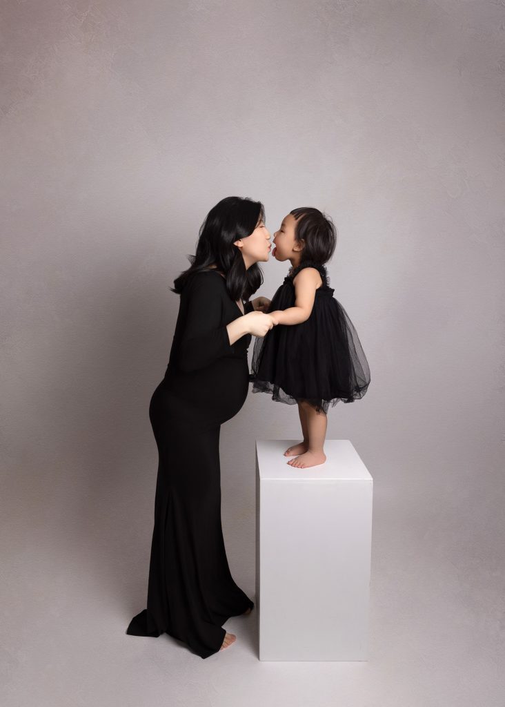 pregent Mom kisses another baby