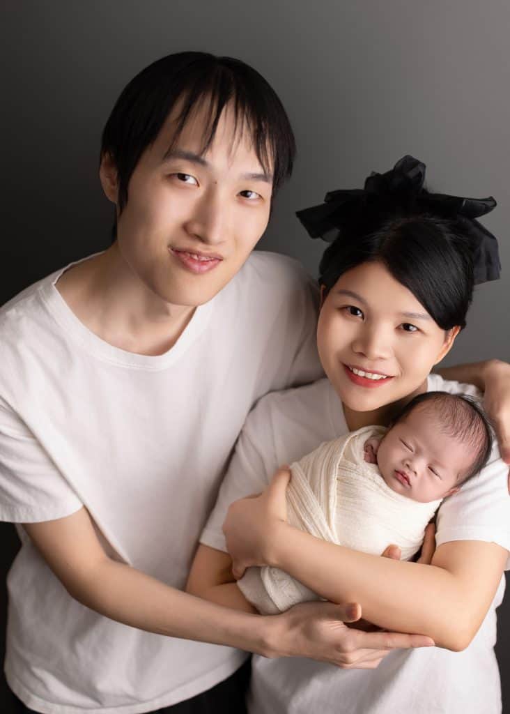 Paretns holding their newborn baby for family photoshoot with newborn in Edmonton