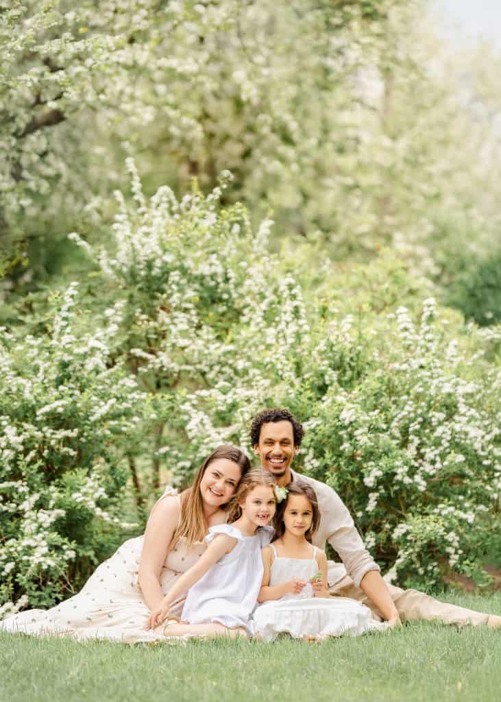 Spring family photo in blooming garden setting in Edmonton
