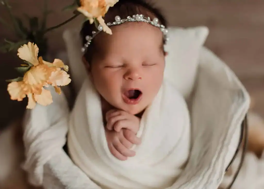 Newborn baby yawning gently during a posed studio session in Edmonton.