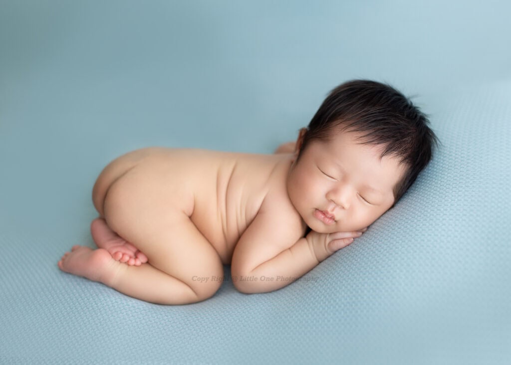 Timeless newborn photo in soft neutral tones by an Edmonton photography studio
