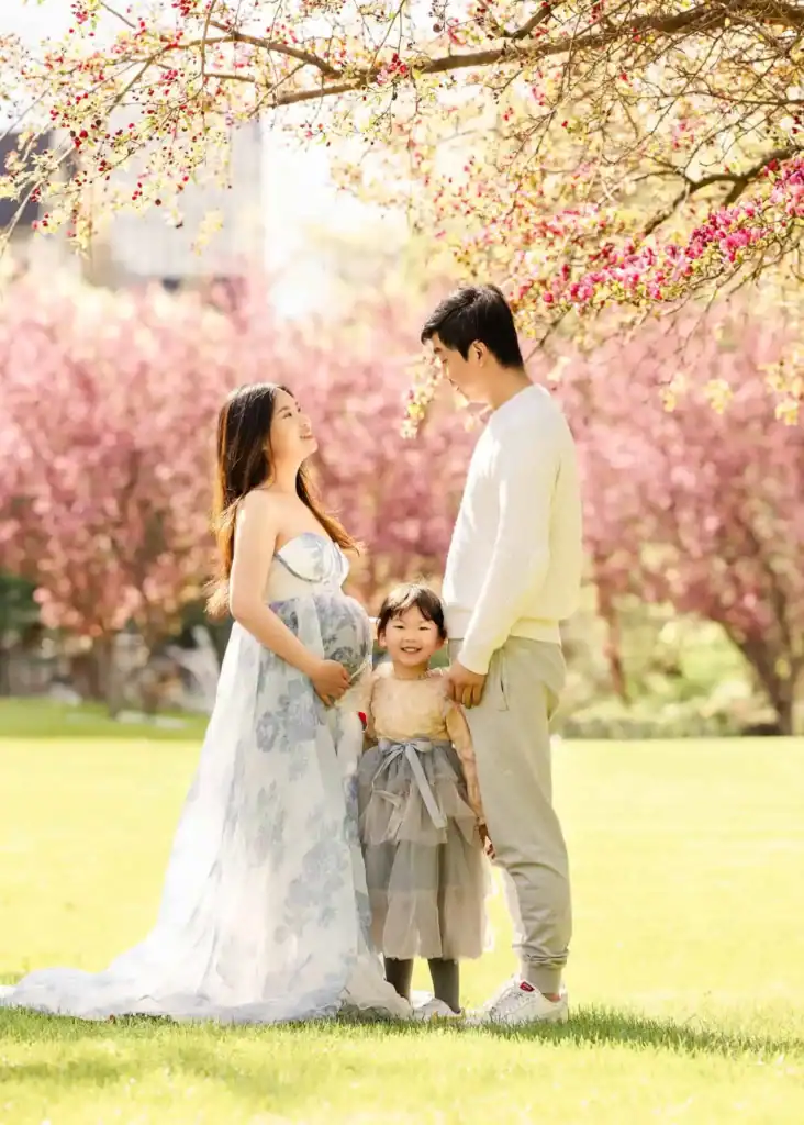 Parents cuddling their toddler during an outdoor family photoshoot in Edmonton