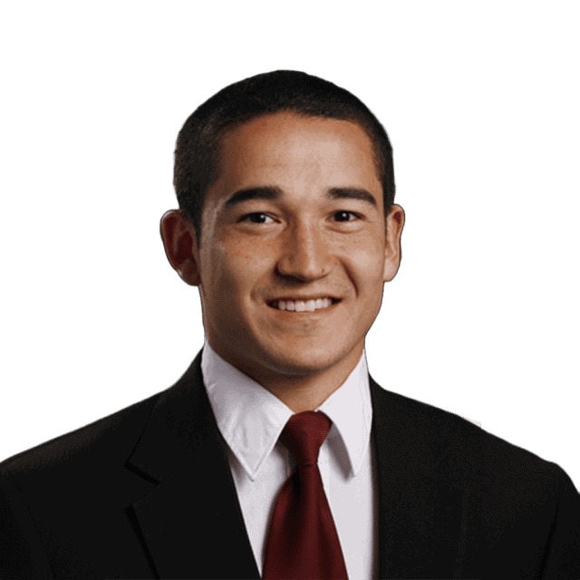 Young man in formal suit smiling, representing Lou Groza Award candidate.