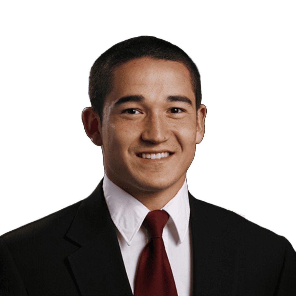 Young man in formal suit smiling, representing Lou Groza Award candidate.