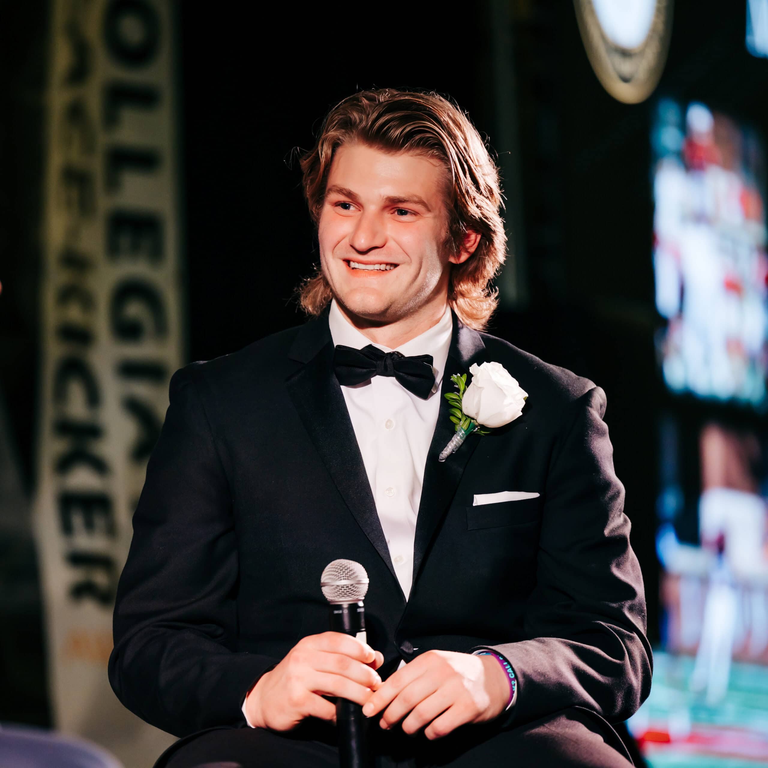 Young man in tuxedo holding microphone at Lou Groza Award ceremony.
