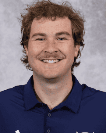 Young man smiling, wearing a blue shirt, portrait for Lou Groza Award.
