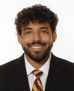 Smiling man in suit with tie, professional headshot for Lou Groza Award.