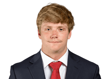 Young male football kicker holding a Lou Groza Award trophy.