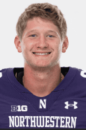 Young football player in Northwestern University jersey smiling for the camera.