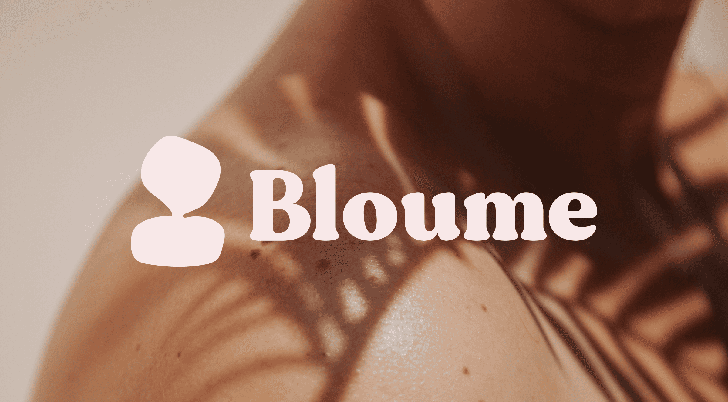 Close-up of a shoulder showing light and shadow patterns on smooth skin with small freckles. The text Bloume is overlaid in white, accompanied by a rounded silhouette icon.