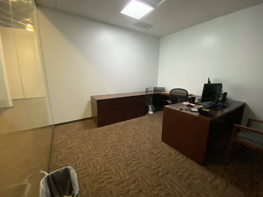 Executive office space with large desk and multiple windows - Kemco commercial build-out Dunwoody